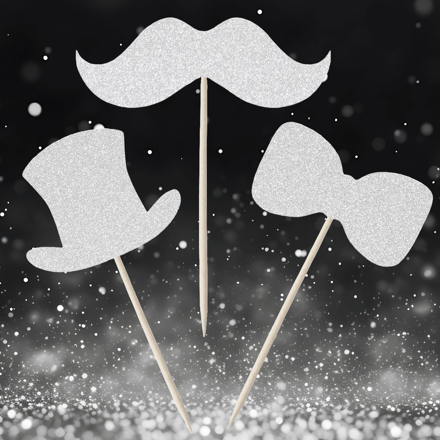 Gentleman themed glitter cupcake toppers in top hat, moustache, and bow tie designs against a sparkly background.