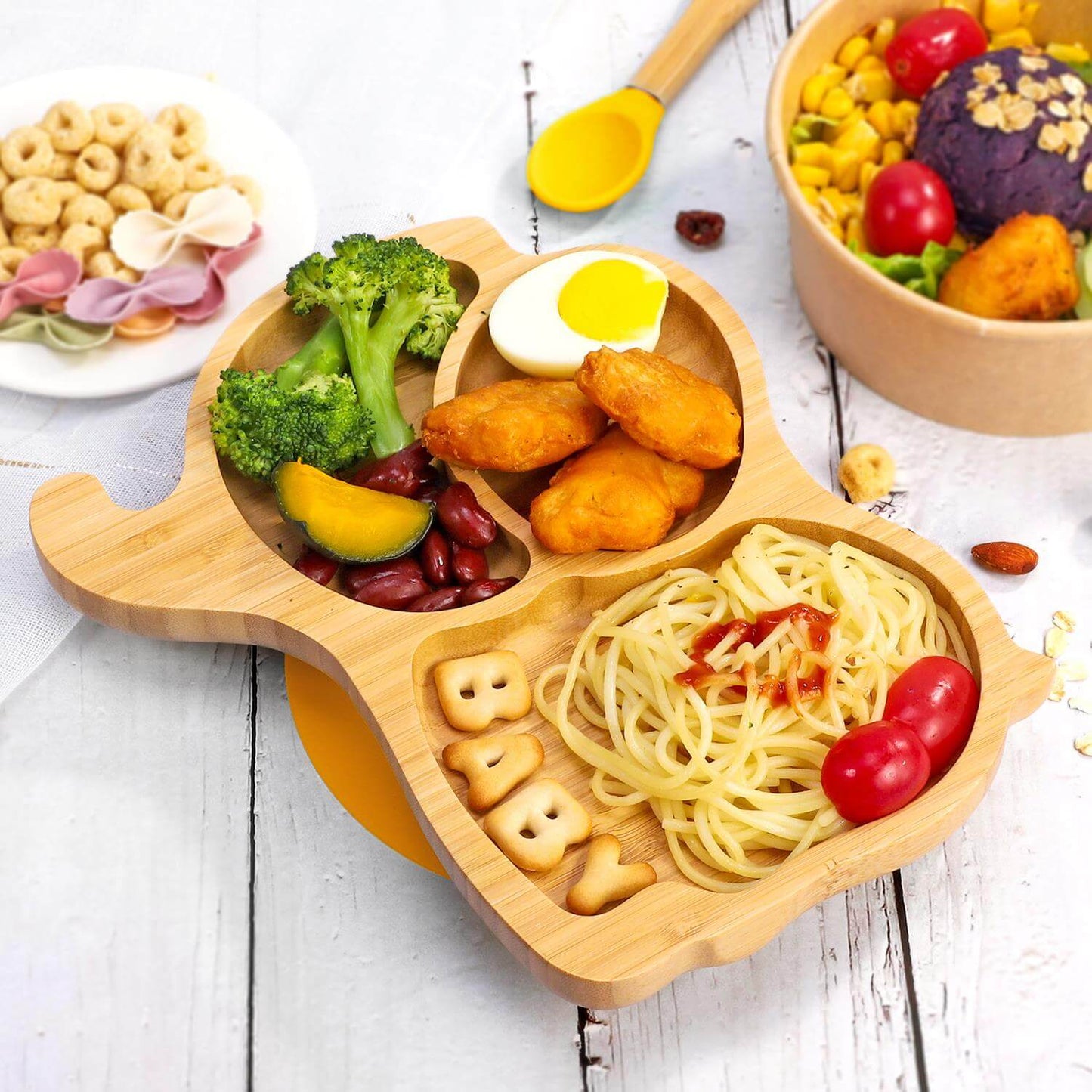 Vinsani bamboo elephant plate with three sections for kids’ meals, featuring broccoli, chicken nuggets, spaghetti, and fruits.
