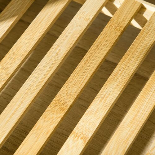 Close-up of bamboo slats showcasing the natural, eco-friendly finish of a sustainable coat rack.