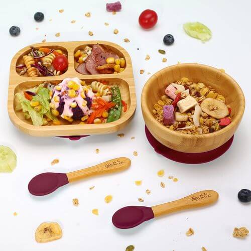 Natural bamboo kids bowl and plate set with healthy meals, featuring non-slip base and easy-clean design, plus wooden spoons.