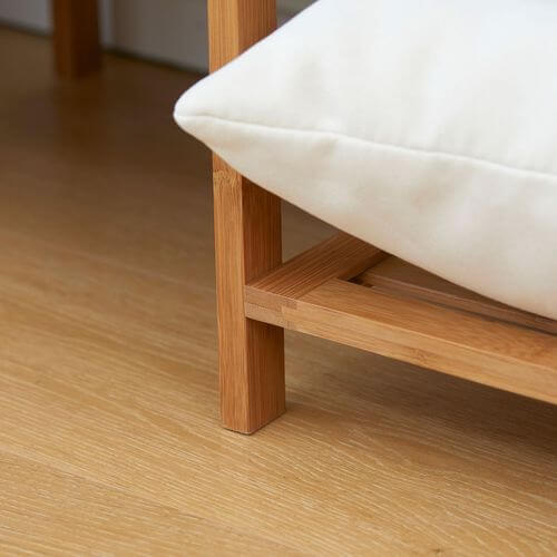 Close-up of a bamboo clothes rail leg and cushion, showcasing sustainable and eco-friendly design.