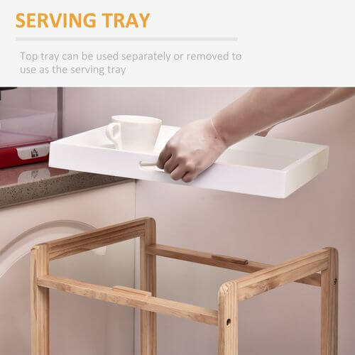White serving tray being lifted from a bamboo kitchen trolley with a cup on it, showcasing its removable convenience.