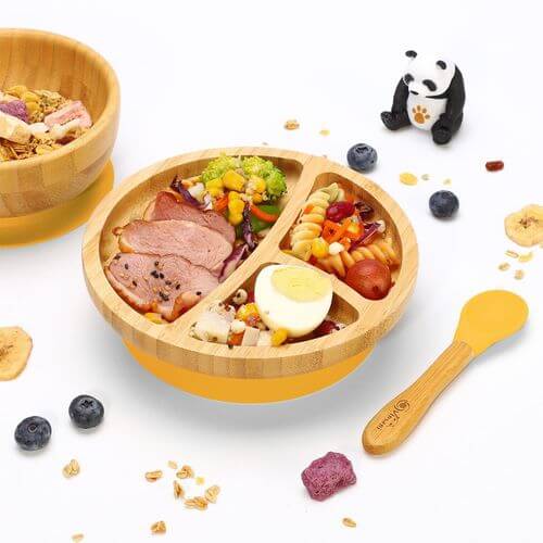 Vinsani bamboo bowl set with divided sections, colorful food, non-slip base, and a wooden spoon for kids' mealtime.
