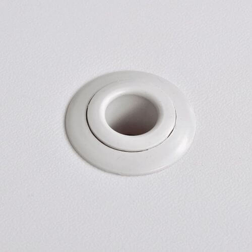 White grommet hole insert for securing outdoor table fittings or accessories.