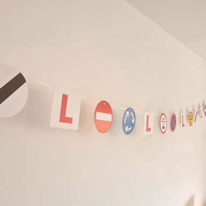 Colorful learner driver bunting with L plates and UK road signs for a fun party decoration.
