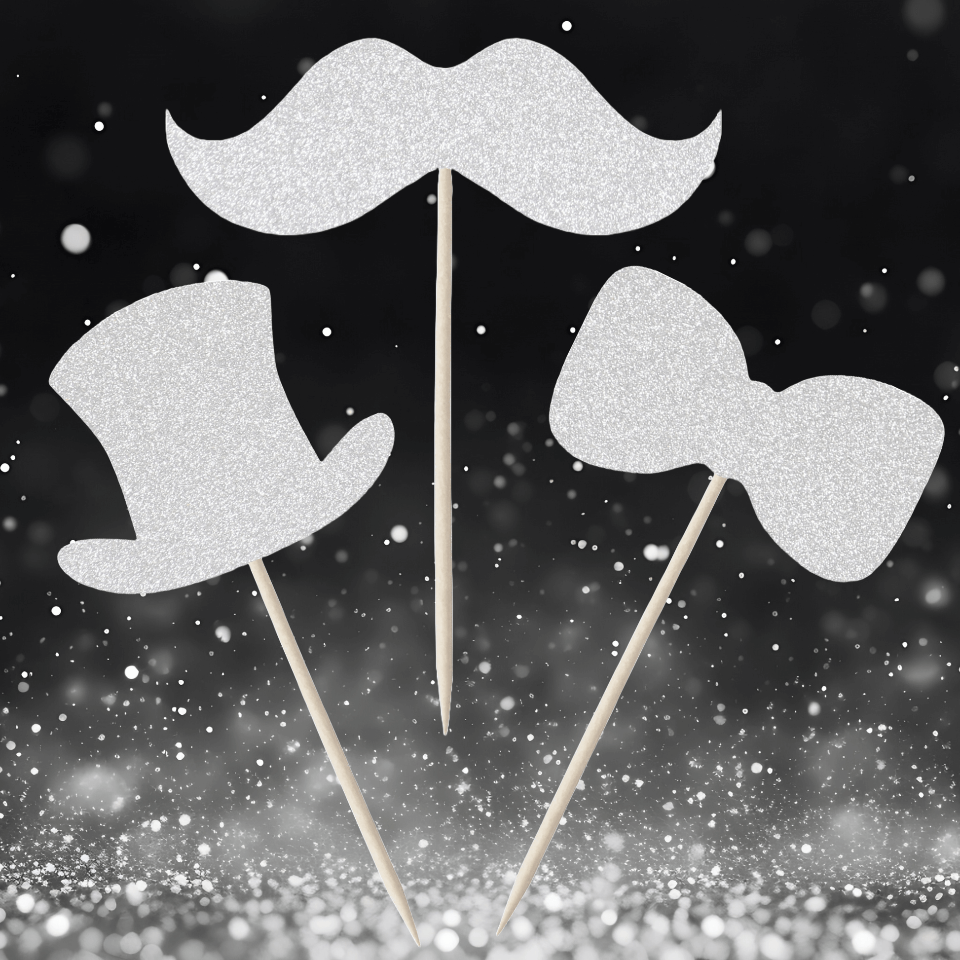Gentleman themed glitter cupcake toppers in top hat, moustache, and bow tie designs against a sparkly background.