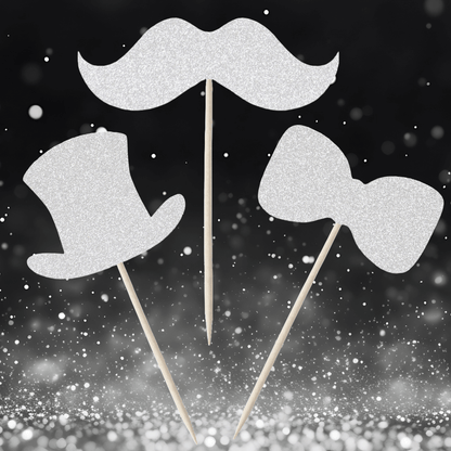 Gentleman themed glitter cupcake toppers in top hat, moustache, and bow tie designs against a sparkly background.