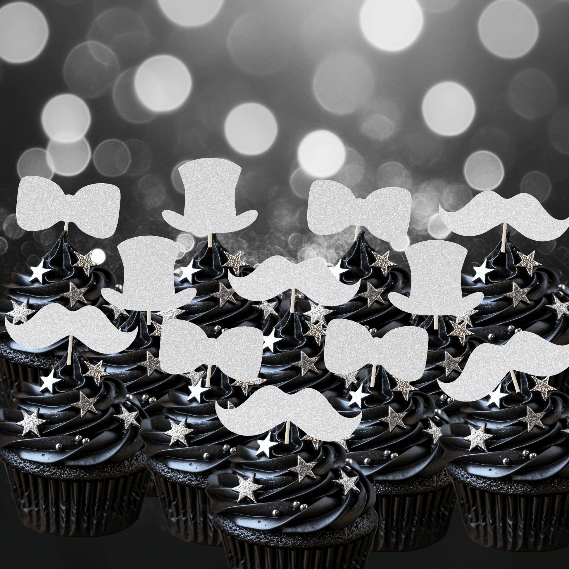 Glitter gentleman themed cupcake toppers on black frosted cupcakes, featuring top hats, moustaches, and bow ties.