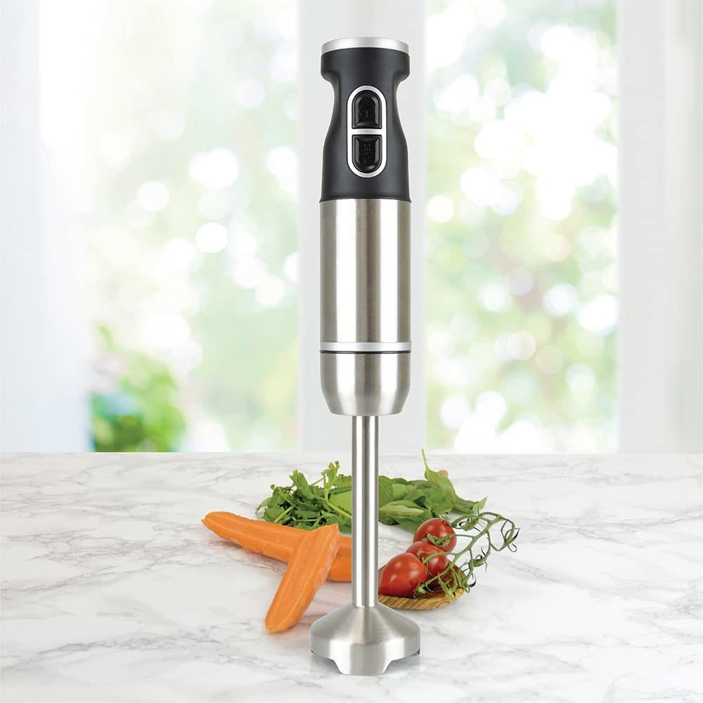 Compact hand blender 700w stainless steel standing on a marble countertop with fresh ingredients.