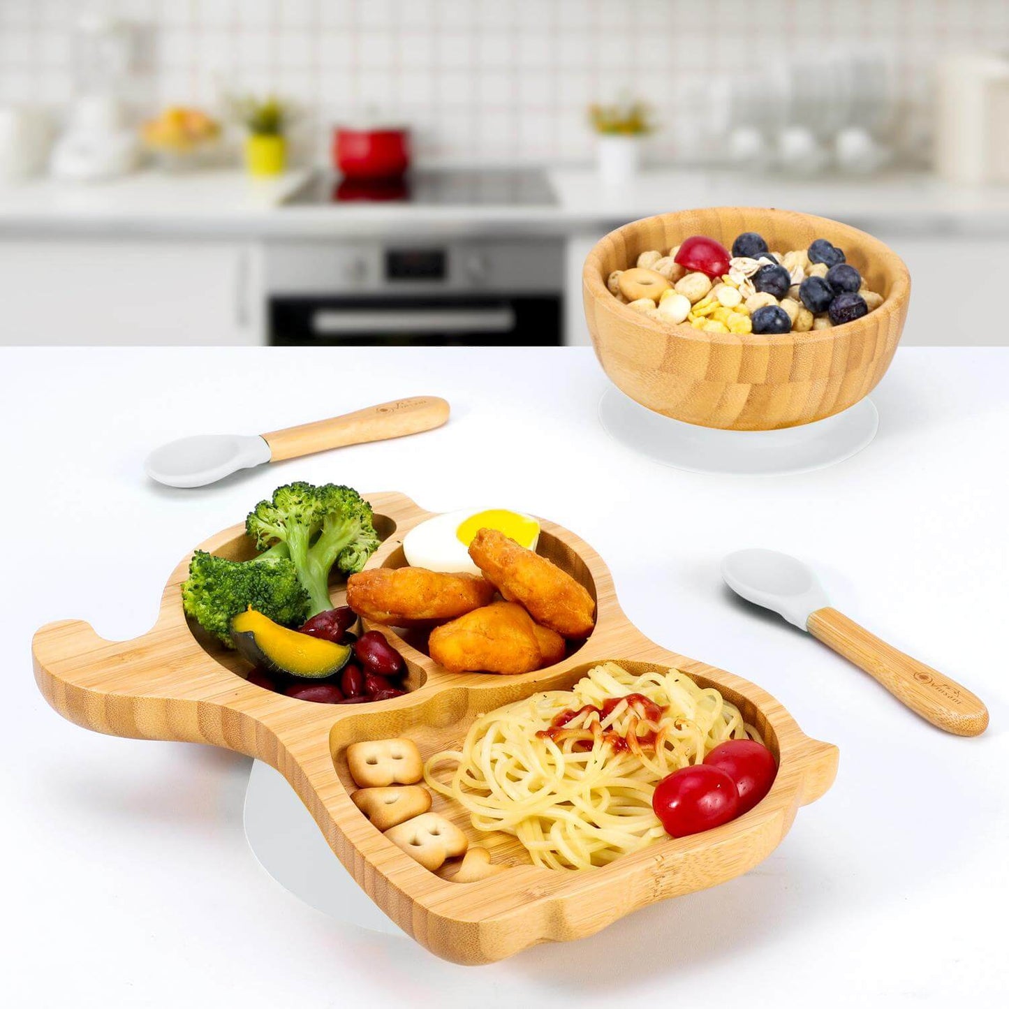 Vinsani bamboo kids plate with 3 sections, bowl, and spoons showcasing healthy meals in a kitchen setting. Non-slip and easy to clean.