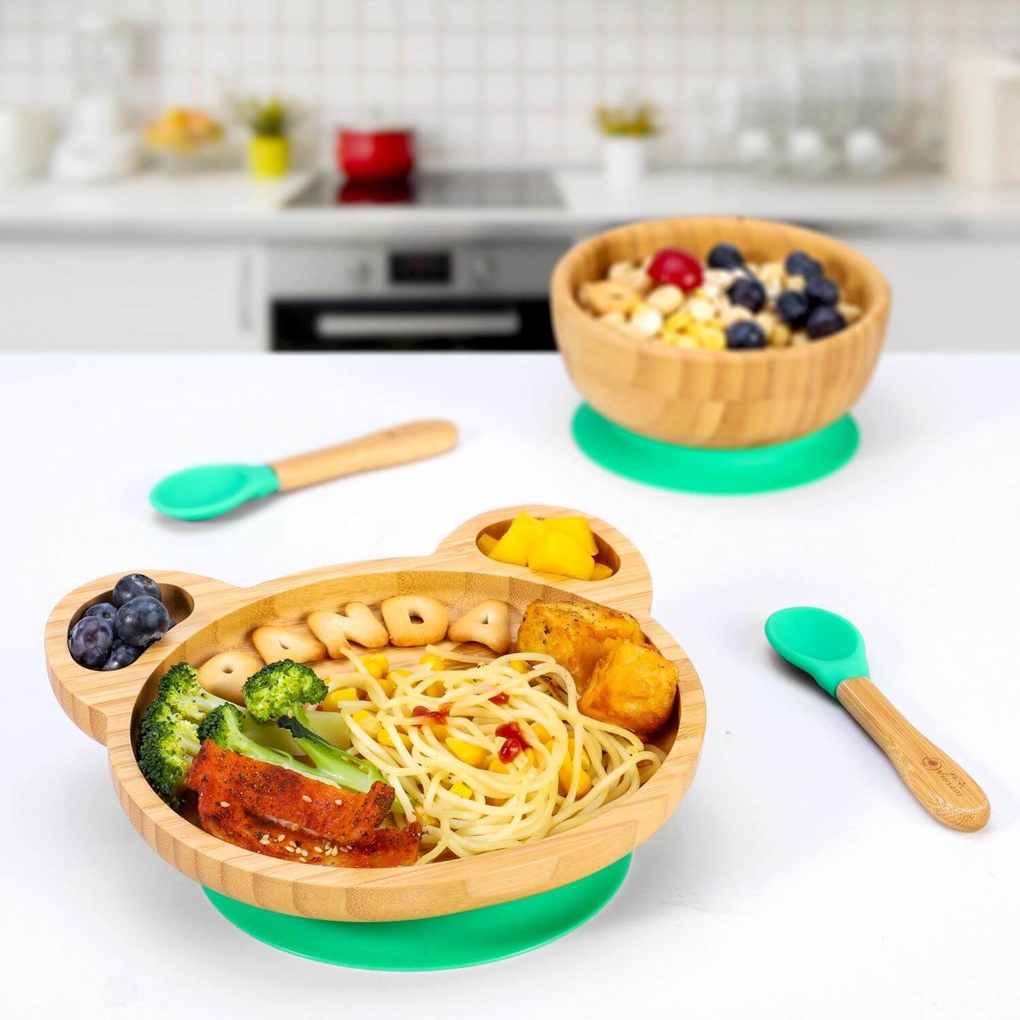 Vinsani bamboo panda plate and bowl set with vibrant food servings and bamboo spoons on a modern kitchen countertop.